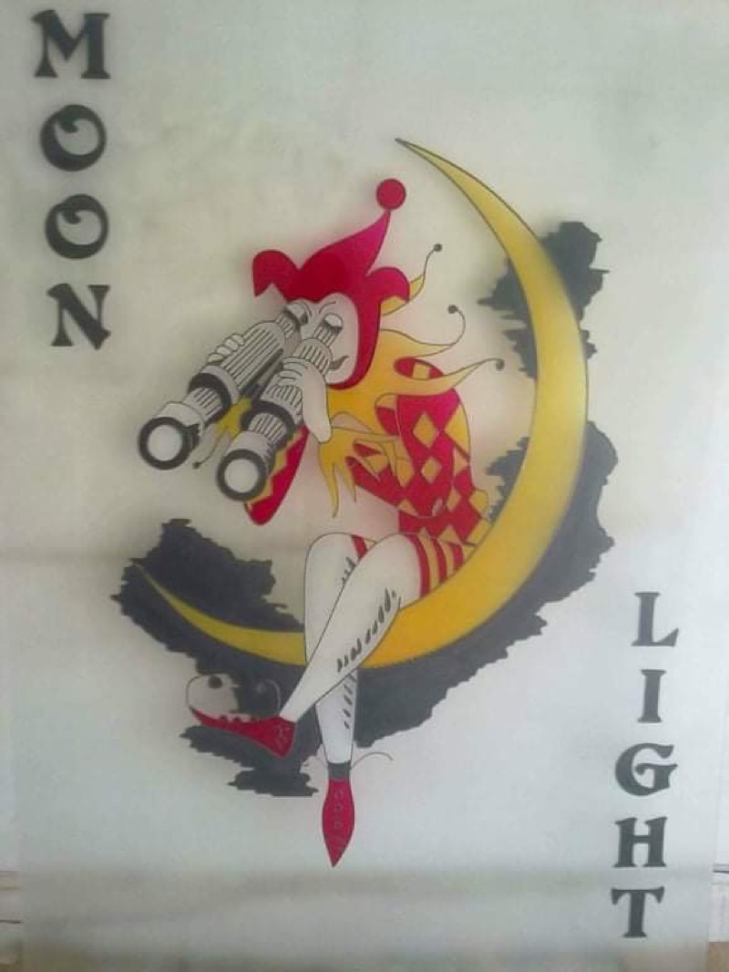 Reverse glass painting of a jester sitting on a crescent moon with binoculars, text reads Moonlight